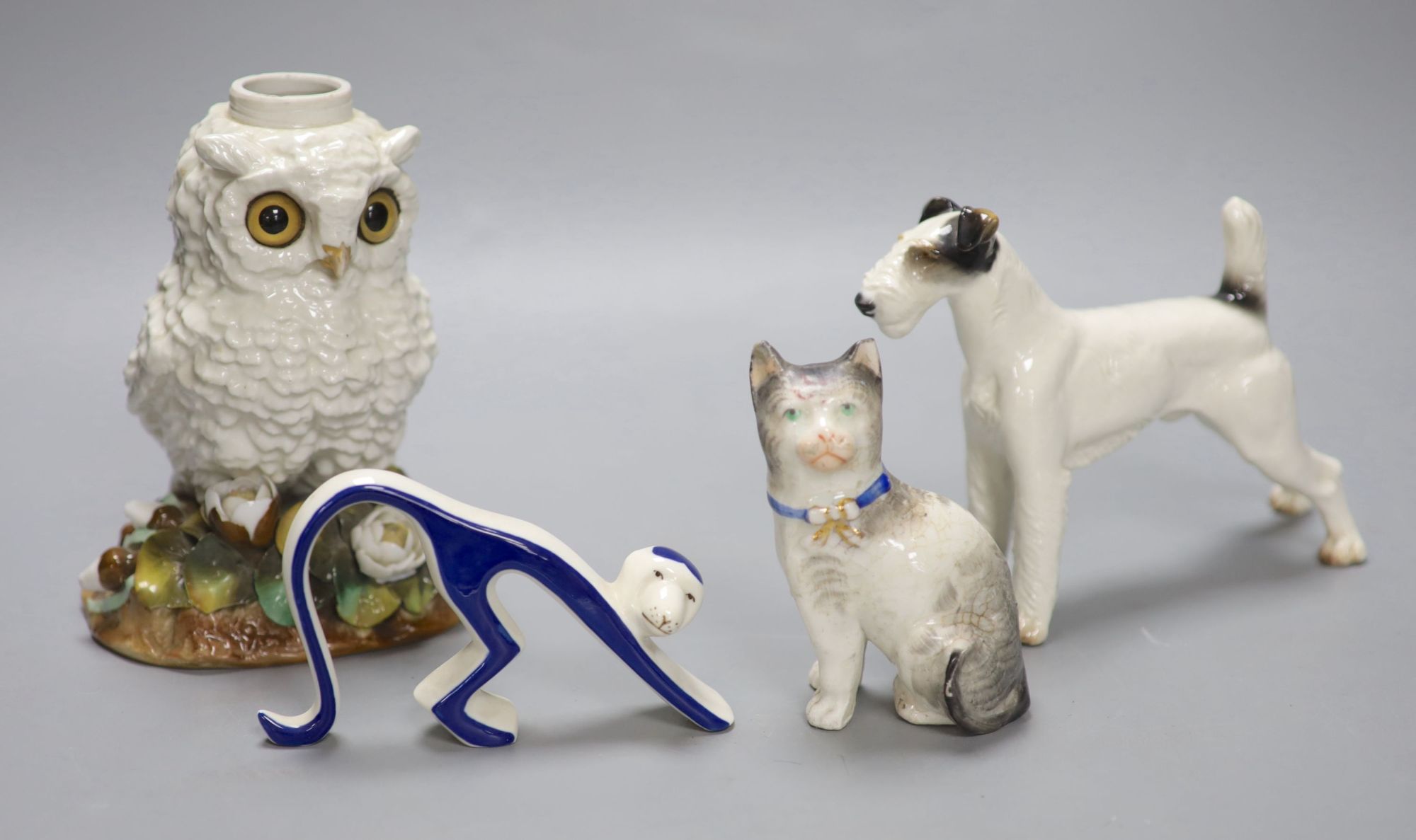 A Victorian porcelain owl oil lamp base, lacking mount, an Austrian porcelain terrier and two other ceramic animals, tallest 16.5cm